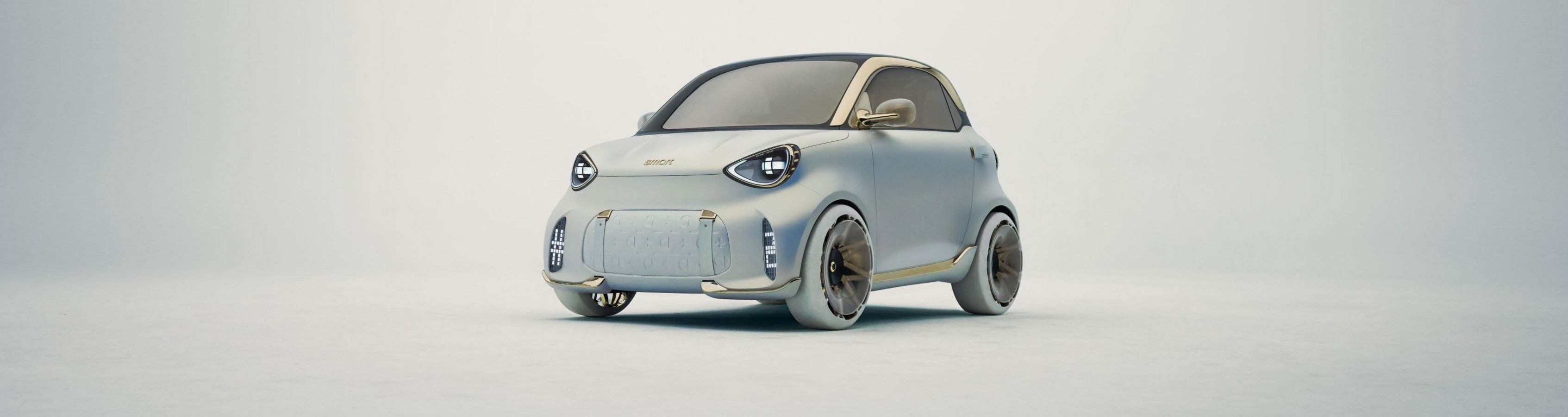 Kleiner kompakter Kleinwagen mit runden Scheinwerfern und glattem, modernem Design vor neutralem Hintergrund